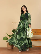 Yezwe Modest Maxi Dress green watercolor wrap with sash belt three quarter sleeves flowing skirt model holding floral basket